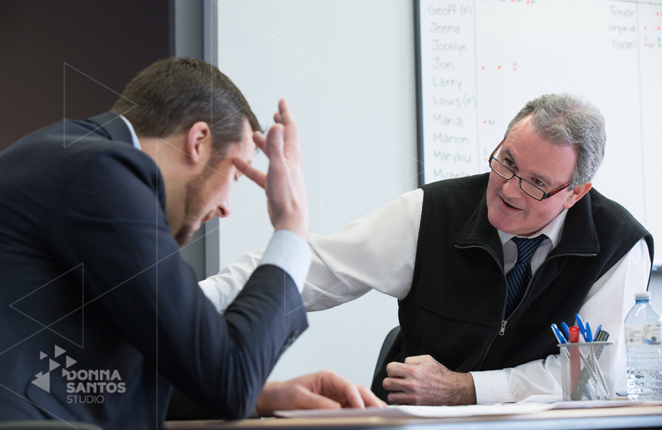 Chris Kelly (left) role playing with his client during a signature Sandler Training session