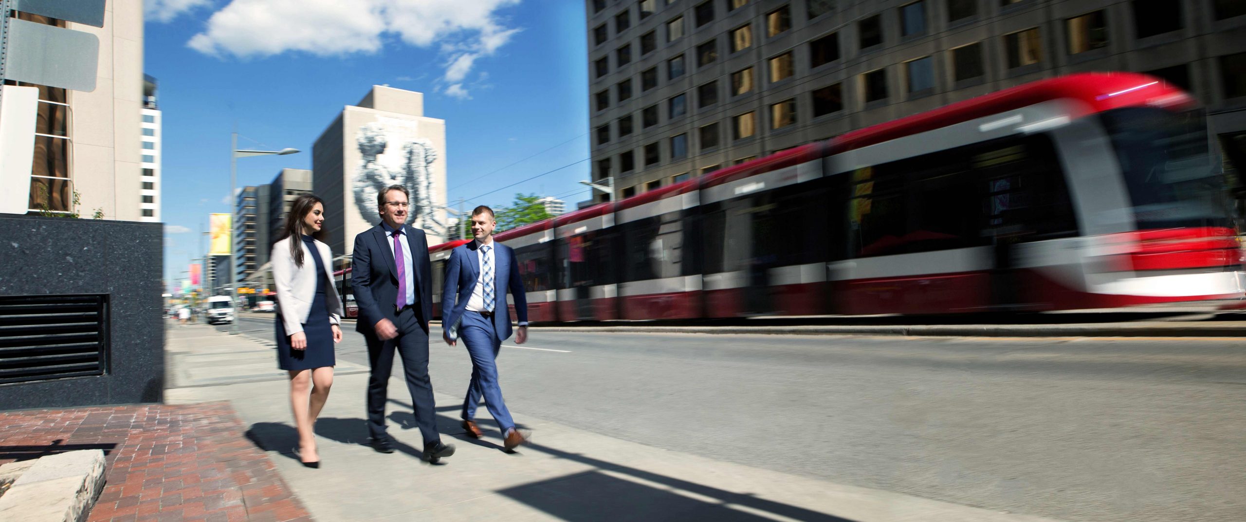 Downtown Toronto with 3 business people walking down the street